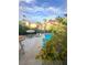 Backyard pool view featuring a spacious patio area, palm trees, and ample seating at 390 Rushing Creek Ct, Henderson, NV 89014