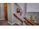 Staircase with wall art and storage cabinets, leading to an upstairs window at 390 Rushing Creek Ct, Henderson, NV 89014