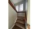 Carpeted stairs going up with a window at the landing and wooden handrails at 390 Rushing Creek Ct, Henderson, NV 89014