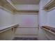 Spacious walk-in closet with shelving and hanging rods provides ample storage space at 390 Rushing Creek Ct, Henderson, NV 89014