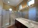 Bright bathroom featuring double sinks, a spacious glass shower, and a large mirror at 4565 Riva De Romanza St, Las Vegas, NV 89135