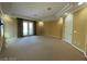 The primary bedroom offers plenty of open space, a door to outside, and bright natural light at 4565 Riva De Romanza St, Las Vegas, NV 89135