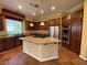 This spacious kitchen features custom cabinets, stainless appliances, and a granite island with gas cooktop at 4565 Riva De Romanza St, Las Vegas, NV 89135