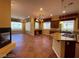Open kitchen and living area with a fireplace, island cooktop, and breakfast bar at 4565 Riva De Romanza St, Las Vegas, NV 89135