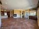 Open living room has custom tile flooring, fireplace, and is conveniently located next to kitchen and bar at 4565 Riva De Romanza St, Las Vegas, NV 89135