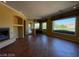 This living room offers abundant natural light, fireplace, and views of desert landscape at 4565 Riva De Romanza St, Las Vegas, NV 89135