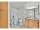 Fresh bathroom features shower with a designer curtain, granite countertop, and ample storage at 5055 W Hacienda Ave # 1136, Las Vegas, NV 89118