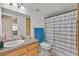 Well-maintained bathroom with granite countertop vanity and shower with a striped curtain at 5055 W Hacienda Ave # 1136, Las Vegas, NV 89118