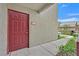 Inviting condo entrance with a vibrant front door and well-kept walkway at 5055 W Hacienda Ave # 1136, Las Vegas, NV 89118