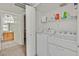 Convenient laundry room with modern washer and dryer, plus shelving for storage at 5055 W Hacienda Ave # 1136, Las Vegas, NV 89118