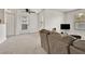 Bright and airy living room with plush carpeting, ceiling fan, and sliding glass door at 5055 W Hacienda Ave # 1136, Las Vegas, NV 89118