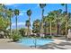 Enjoy the community pool surrounded by tropical palm trees and green landscaping, creating a relaxing and inviting atmosphere at 5055 W Hacienda Ave # 1136, Las Vegas, NV 89118