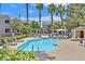 A refreshing community pool, surrounded by lounge chairs, palm trees, and lush greenery, provides an oasis for residents at 5055 W Hacienda Ave # 1136, Las Vegas, NV 89118