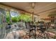 Inviting back patio featuring stylish dining set, ceiling fan, and landscaped yard at 5305 Bright Sun Ct, Las Vegas, NV 89130