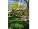 View of the backyard with lush green grass and mature trees at 5305 Bright Sun Ct, Las Vegas, NV 89130
