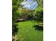 Beautiful backyard with a lush lawn and mature trees, offering a serene outdoor retreat at 5305 Bright Sun Ct, Las Vegas, NV 89130