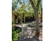 Picturesque backyard featuring stone table, benches and lush landscaping for outdoor relaxation at 5305 Bright Sun Ct, Las Vegas, NV 89130