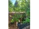 Backyard garden area with decorative planters, lush greenery, and a small angel statue at 5305 Bright Sun Ct, Las Vegas, NV 89130