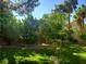 Expansive backyard with lush lawn, mature trees, and brick-lined garden beds for serene outdoor living at 5305 Bright Sun Ct, Las Vegas, NV 89130