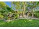 Beautiful backyard featuring lawn and patio area, with mature trees and shrubs at 5305 Bright Sun Ct, Las Vegas, NV 89130