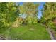 Lush backyard featuring healthy green lawn and mature trees and shrubs at 5305 Bright Sun Ct, Las Vegas, NV 89130