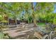 Relaxing backyard patio with comfortable lounge chair surrounded by lush greenery and shade at 5305 Bright Sun Ct, Las Vegas, NV 89130