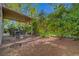 Expansive backyard featuring a covered patio and a mix of gravel and paved areas at 5305 Bright Sun Ct, Las Vegas, NV 89130