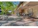 Spacious backyard patio with dining area, barbecue, seating, and lush landscaping at 5305 Bright Sun Ct, Las Vegas, NV 89130