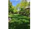 Green backyard with well-maintained lawn and lush greenery provides a peaceful outdoor space at 5305 Bright Sun Ct, Las Vegas, NV 89130