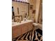Bathroom with double vanity and shower over tub at 5305 Bright Sun Ct, Las Vegas, NV 89130