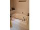 Corner soaking bathtub with white tiled surround and a chrome faucet at 5305 Bright Sun Ct, Las Vegas, NV 89130