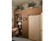 Bedroom area with a neutral-toned wall, showcasing shelving decor and sliding closet doors at 5305 Bright Sun Ct, Las Vegas, NV 89130
