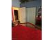 Comfortable bedroom with a red bedspread, white closet doors, and mirror reflecting the space at 5305 Bright Sun Ct, Las Vegas, NV 89130