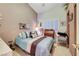Cozy bedroom with striped bedding, window shutters, and vintage writing desk at 5305 Bright Sun Ct, Las Vegas, NV 89130