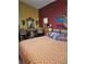 Bedroom featuring unique decor, including an elephant table, colorful walls, and ceiling fan at 5305 Bright Sun Ct, Las Vegas, NV 89130
