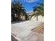 Exterior shot of the home with a spacious driveway and low-maintenance desert landscaping at 5305 Bright Sun Ct, Las Vegas, NV 89130