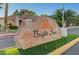 Community entrance sign for Bright Sun on an island of green at 5305 Bright Sun Ct, Las Vegas, NV 89130