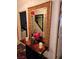 An ornate gold-framed mirror on a table adds elegance to the entryway at 5305 Bright Sun Ct, Las Vegas, NV 89130