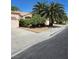 Well-maintained home with a large driveway, mature landscaping, and a welcoming curb appeal at 5305 Bright Sun Ct, Las Vegas, NV 89130