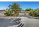 Charming single-story home featuring a three-car garage, mature landscaping, and a well-maintained front yard at 5305 Bright Sun Ct, Las Vegas, NV 89130