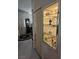 Hallway featuring built-in mirrored cabinet, tiled floors, and doorway to the main room at 5305 Bright Sun Ct, Las Vegas, NV 89130