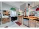 Bright kitchen features a breakfast bar, custom mural, granite counters, and modern stainless appliances at 5305 Bright Sun Ct, Las Vegas, NV 89130