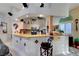 Bright kitchen features a breakfast bar, custom mural, granite counters, and modern stainless appliances at 5305 Bright Sun Ct, Las Vegas, NV 89130