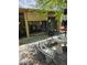 Charming outdoor patio with mosaic table and bench, fire pit, and seating area at 5305 Bright Sun Ct, Las Vegas, NV 89130