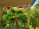 Covered patio featuring lush, tropical greenery and flag bunting at 5305 Bright Sun Ct, Las Vegas, NV 89130