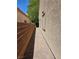 This side yard features a stone walkway and a tall wall for added privacy at 5305 Bright Sun Ct, Las Vegas, NV 89130