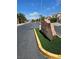 Neighborhood street featuring community signage, manicured landscaping, and well-maintained streets at 5305 Bright Sun Ct, Las Vegas, NV 89130