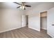 Bedroom with wood-look flooring, ceiling fan, and closet storage at 5330 E Charleston Blvd # 28, Las Vegas, NV 89142
