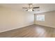 Bright bedroom with wood-look floors, a ceiling fan, and a sunny window at 5330 E Charleston Blvd # 28, Las Vegas, NV 89142
