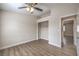 Bedroom featuring durable floors, a ceiling fan, walk-in closet, and a view to another room at 5330 E Charleston Blvd # 28, Las Vegas, NV 89142